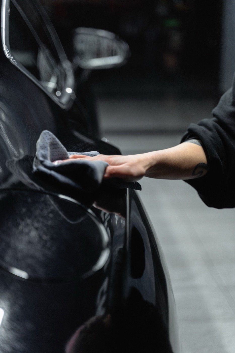 A folded microfiber towel mid pass on black paint